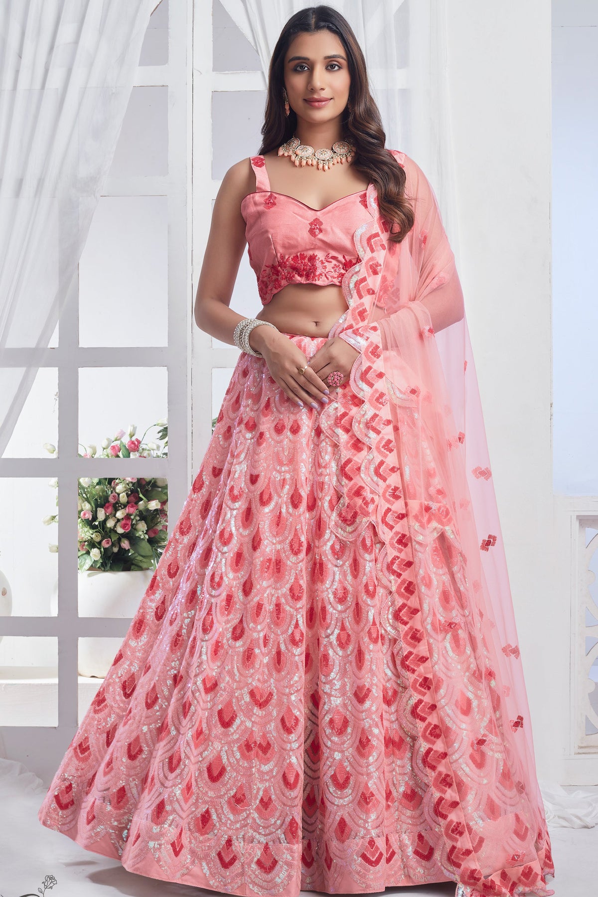 Fashionable Peach Color Sequins Work Net Fabric Lehenga