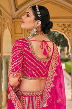 Load image into Gallery viewer, Silk Fabric Rani Color Embroidered Work Soothing Bridal Lehenga With Double Dupatta
