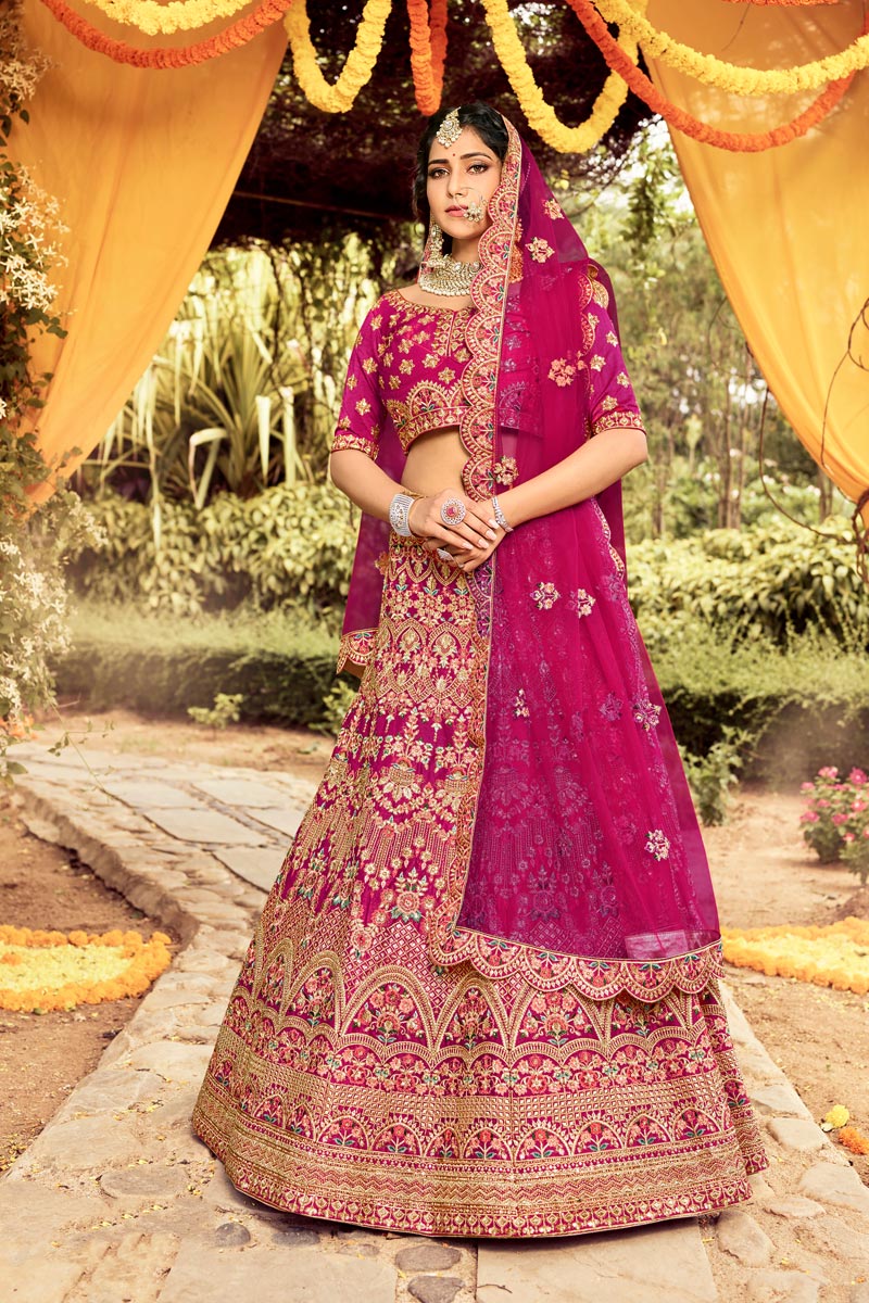 Art Silk Fabric Rani Color Bridal Lehenga With Fascinating Embroidered Work