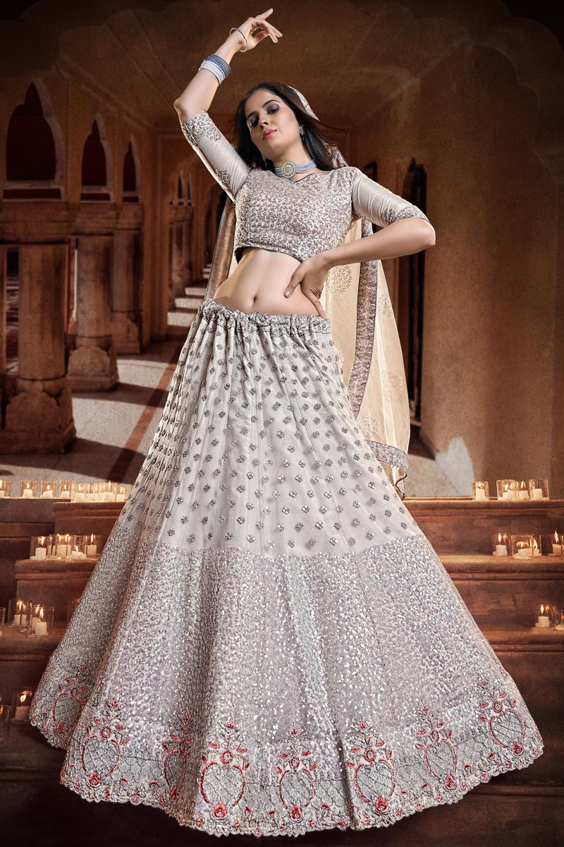 Glamorous Georgette And Net Sequins Work Lehenga Choli In Cream Color