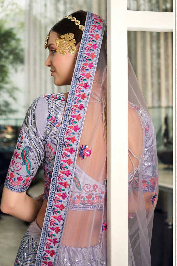 Riveting EmbroideLavender Silk Fabric  Wedding Wear Lehenga In Lavender Color