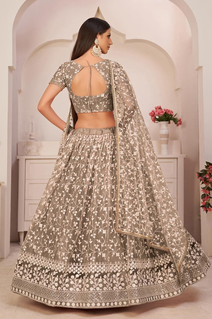Chikoo Color Sangeet Wear Net Fabric Lehenga Choli With Tempting Embroidered Work
