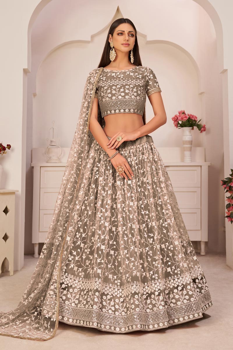 Chikoo Color Sangeet Wear Net Fabric Lehenga Choli With Tempting Embroidered Work