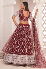 Load image into Gallery viewer, Net Fabric Sangeet Wear Maroon Color Striking Embroidered Lehenga
