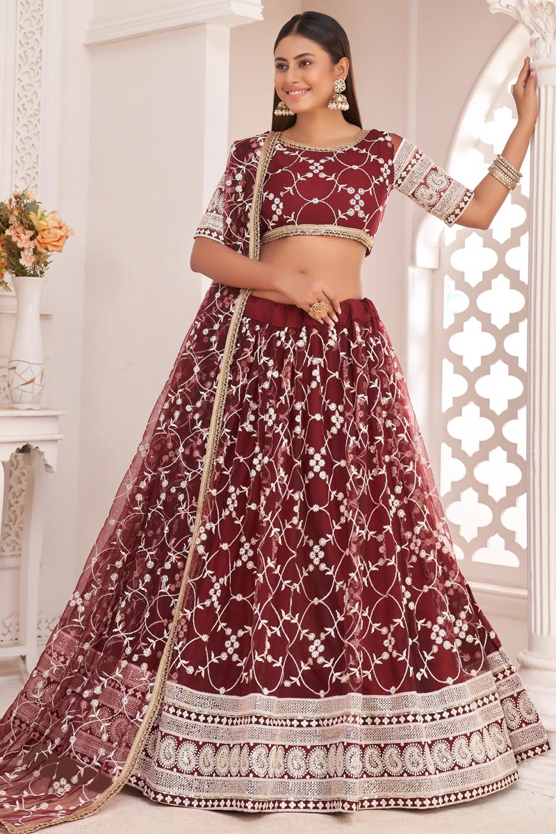 Net Fabric Sangeet Wear Maroon Color Striking Embroidered Lehenga