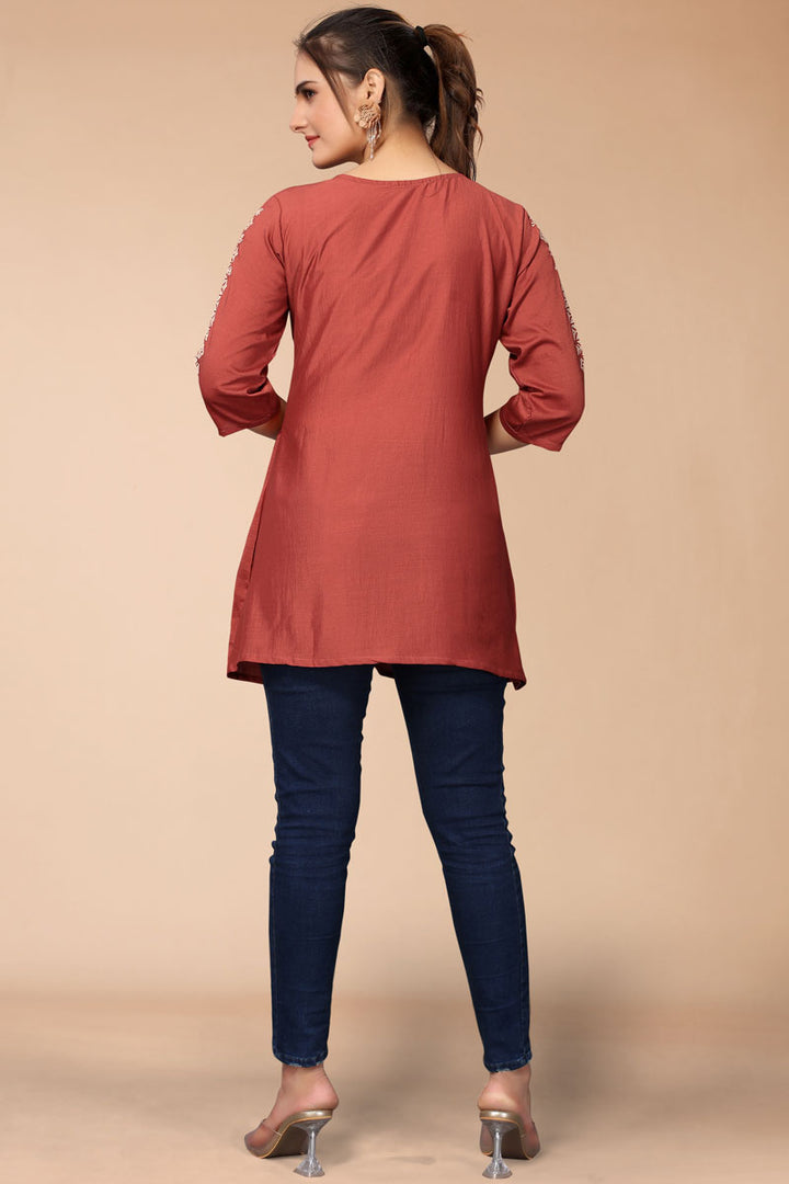 Creative Embroidered Work On Rayon Fabric Short Kurti In Rust Color