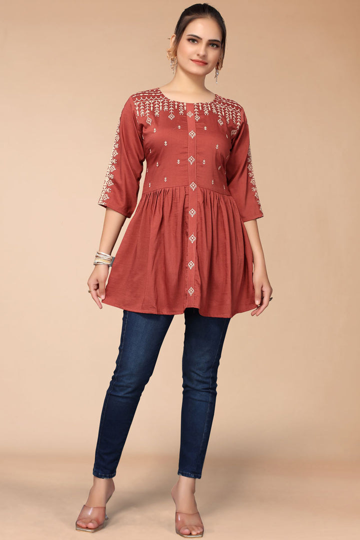 Creative Embroidered Work On Rayon Fabric Short Kurti In Rust Color