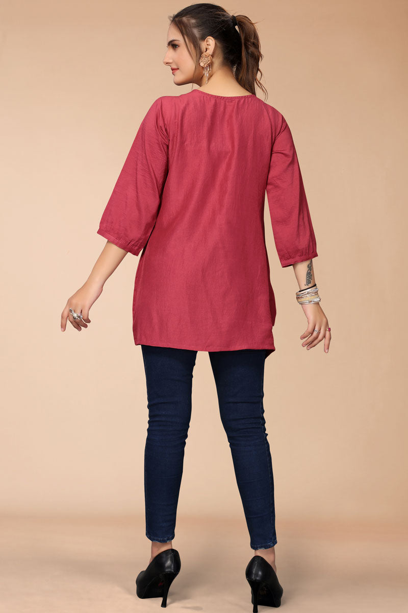 Bewitching Embroidered Work On Rani Color Short Kurti In Rayon Fabric