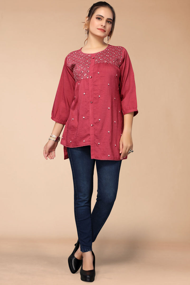 Bewitching Embroidered Work On Rani Color Short Kurti In Rayon Fabric
