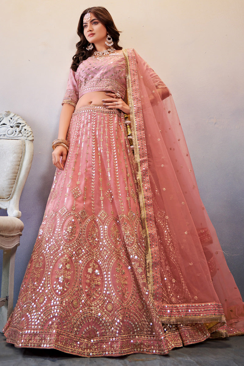 Net Fabric Peach Color Riveting Lehenga Choli With Sequins Work