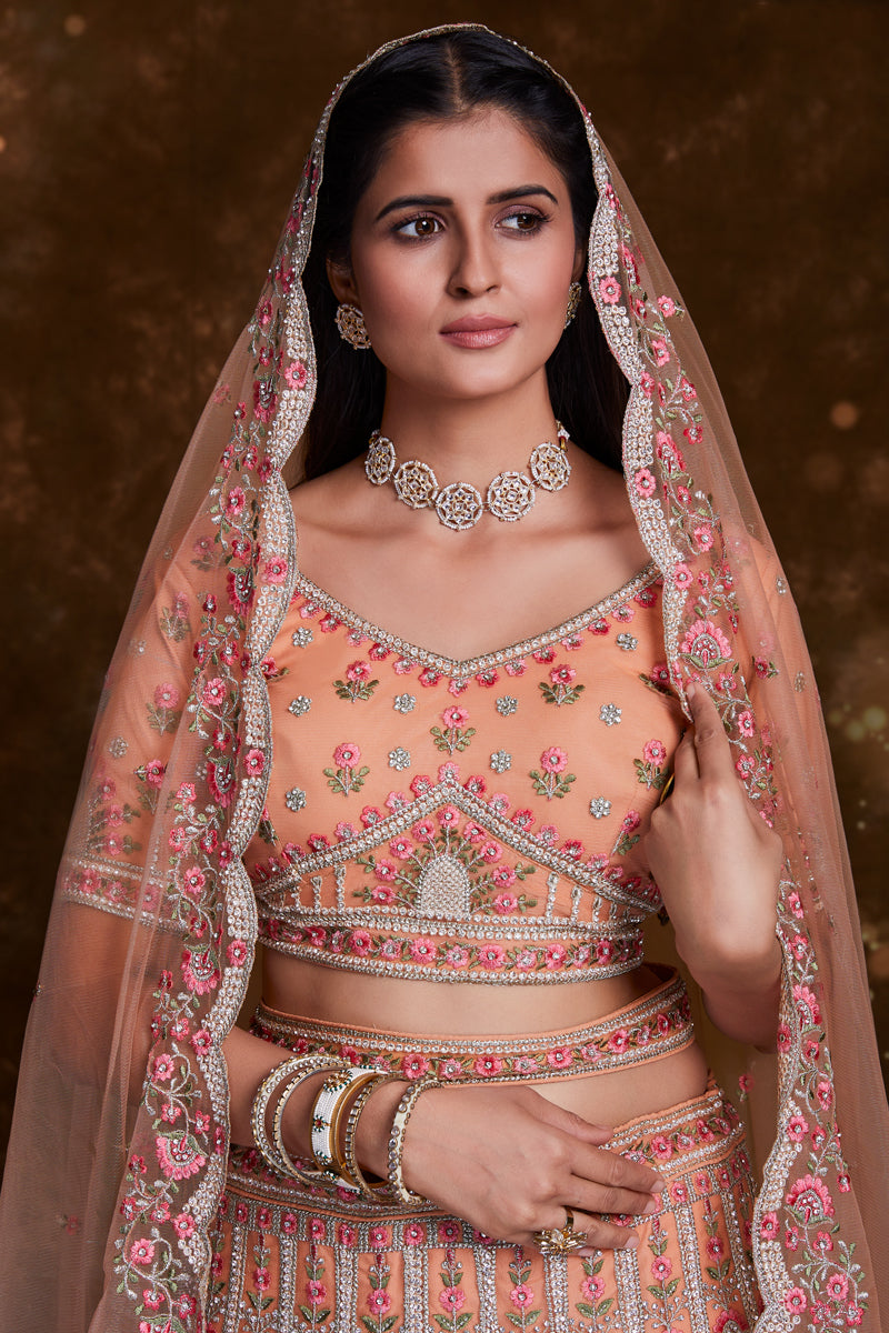 Net Wedding Wear Chaniya Choli In Peach With Embroidery Work And Designer Blouse