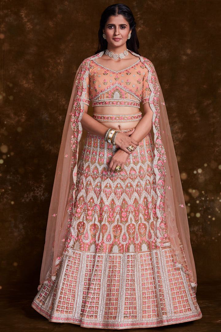 Net Wedding Wear Chaniya Choli In Peach With Embroidery Work And Designer Blouse