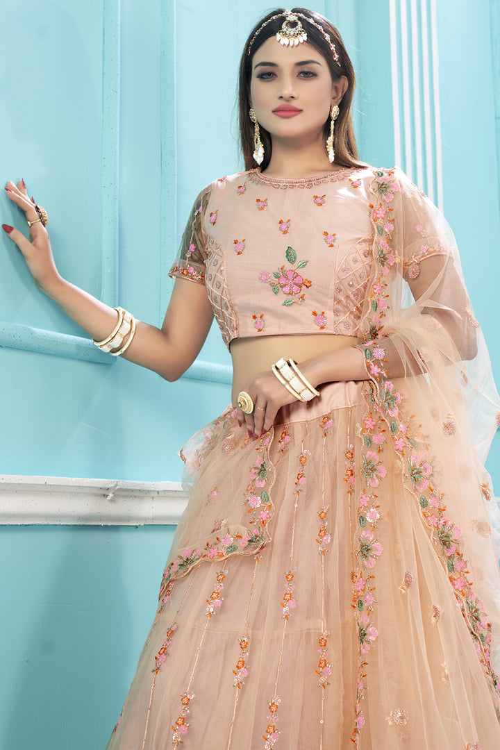 Attractive Floral Embroidered Work Net Fabric Lehenga Choli In Peach Color