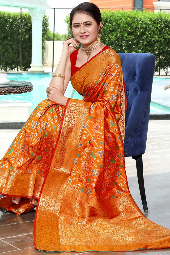 Festival Wear Banarasi Style Art Silk Fabric Orange Color Adoring Patola Print Saree