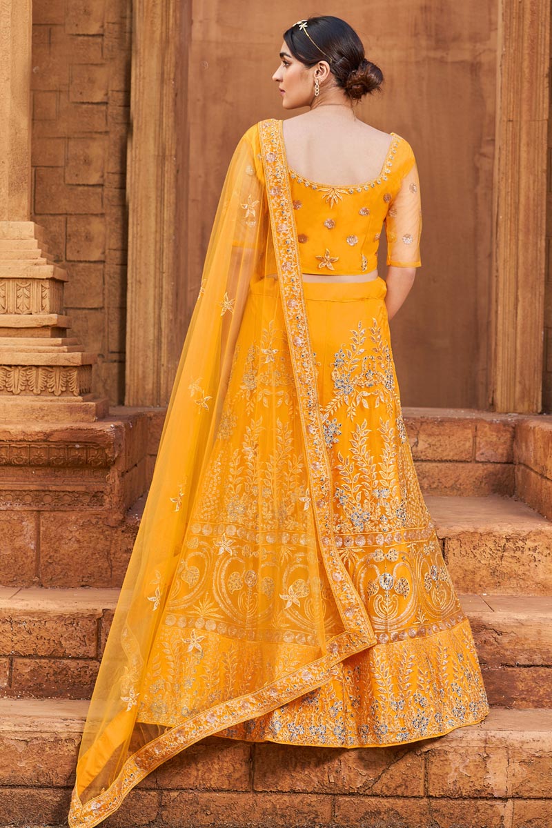 Net Fabric Brilliant Function Wear Lehenga In Yellow Color