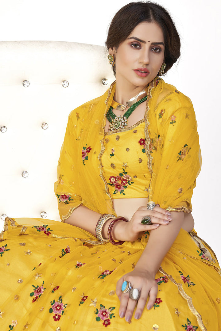 Beautiful Net Fabric Sangeet Wear Embroidered Lehenga Choli In Yellow Color