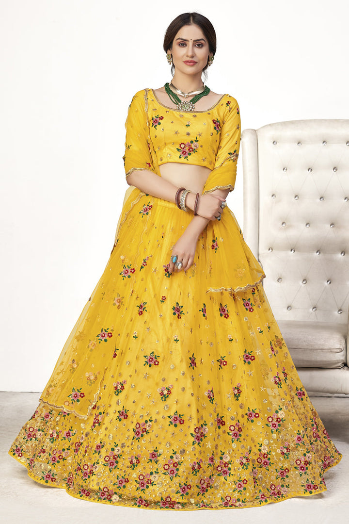 Beautiful Net Fabric Sangeet Wear Embroidered Lehenga Choli In Yellow Color