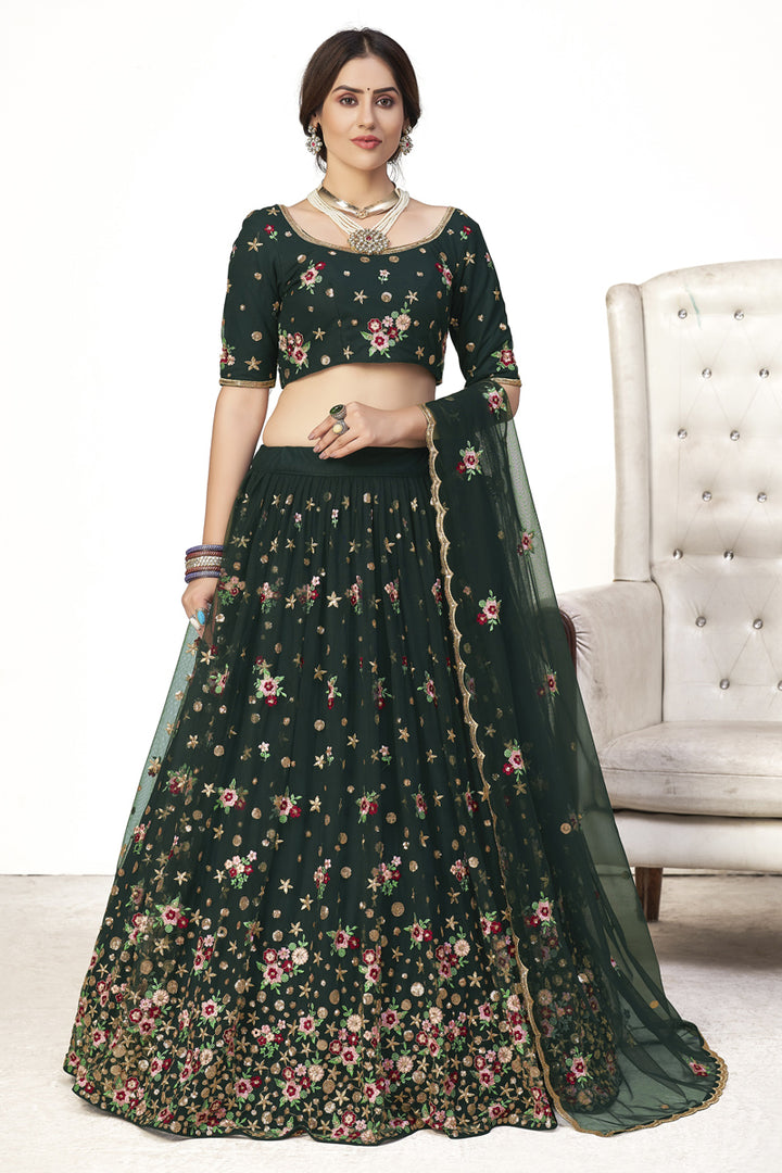 Attractive Sangeet Wear Dark Green Color Embroidered Lehenga In Net Fabric