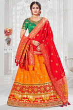 Load image into Gallery viewer, Orange Color Sangeet Wear Adorning Embroidered Work Silk Lehenga
