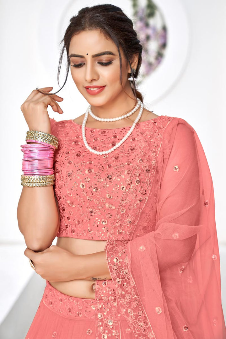 Gorgeous Peach Embroidered Sangeet Wear Lehenga Choli In Net Fabric