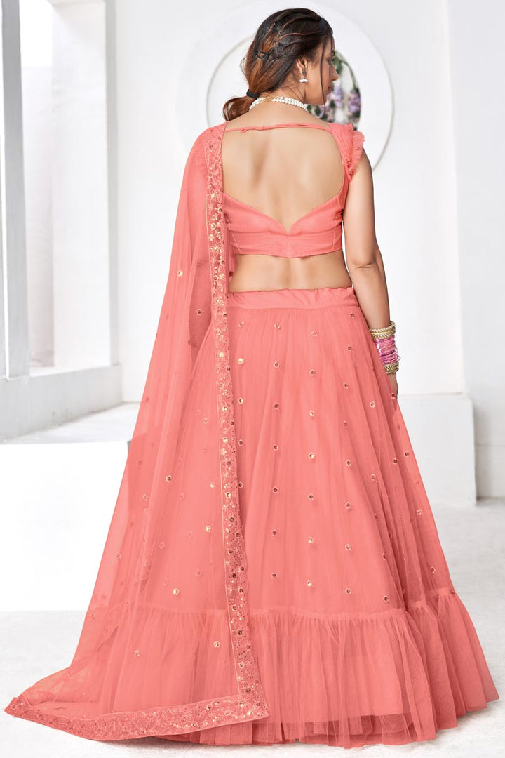 Gorgeous Peach Embroidered Sangeet Wear Lehenga Choli In Net Fabric