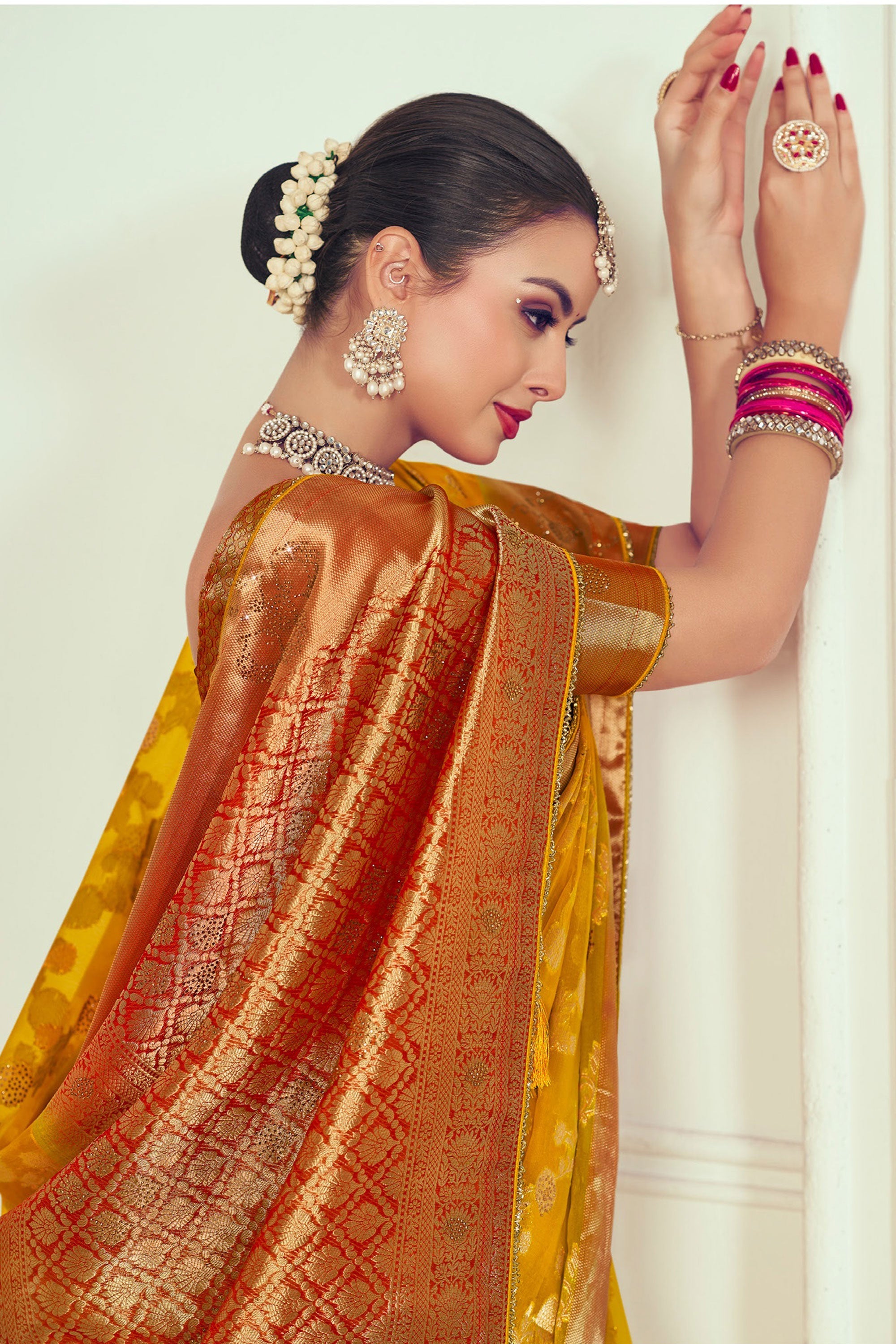 Mustard Color Organza Fabric Radiant Weaving And Stone Work Saree