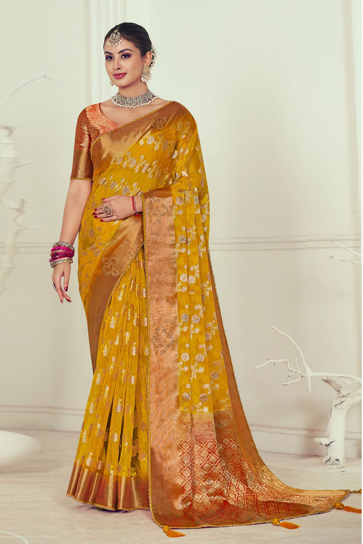 Mustard Color Organza Fabric Radiant Weaving And Stone Work Saree