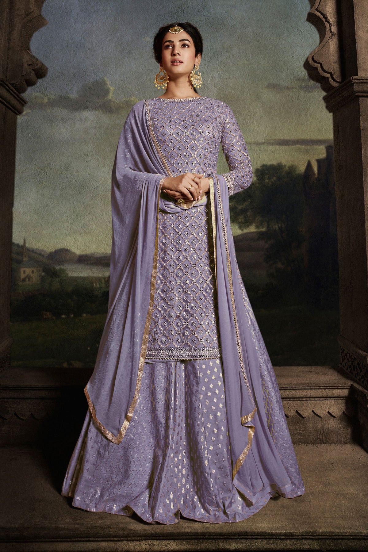 Sonal Chauhan Appealing Embroidered Work On Net Fabric Sharara Top Lehenga In Lavender Color