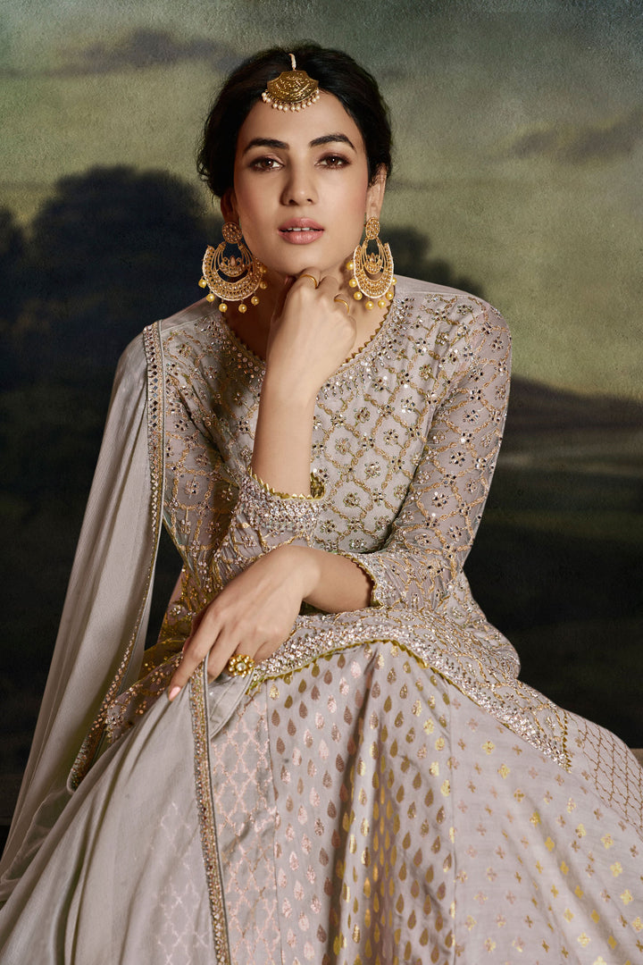 Sonal Chauhan Imperial Beige Color Net Fabric Sharara Top Lehenga With Embroidered Work