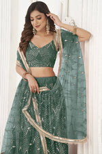 Load image into Gallery viewer, Phenomenal Sangeet Wear Dark Green Color Net Fabric Lehenga Choli
