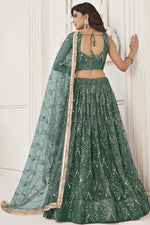 Load image into Gallery viewer, Phenomenal Sangeet Wear Dark Green Color Net Fabric Lehenga Choli

