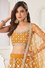 Load image into Gallery viewer, Mustard Color Net Wedding Wear Lehenga Choli With Embroidery Work