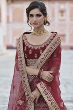 Load image into Gallery viewer, Velvet Heavy Embroidered Wedding Wear Lehenga Choli In Maroon Color
