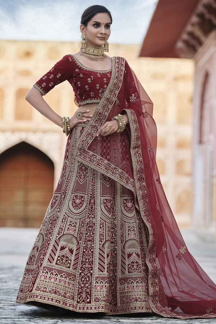 Velvet Heavy Embroidered Wedding Wear Designer Lehenga Choli In Maroon Color