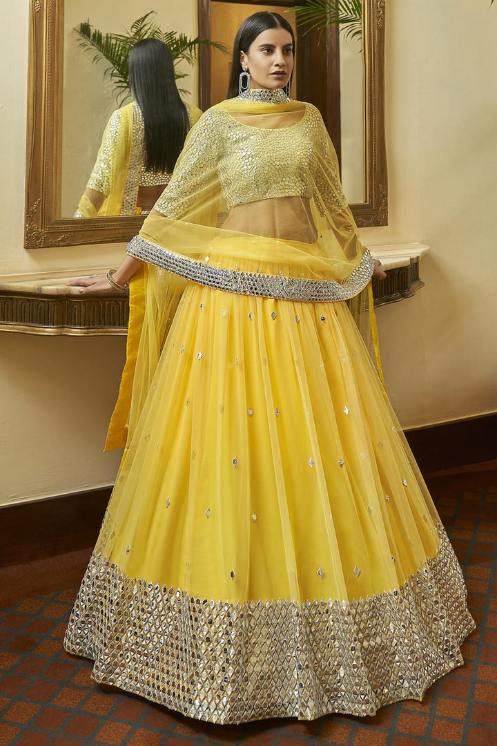 Sangeet Wear Net Fabric Chic Embroidered Lehenga Choli In Yellow Color