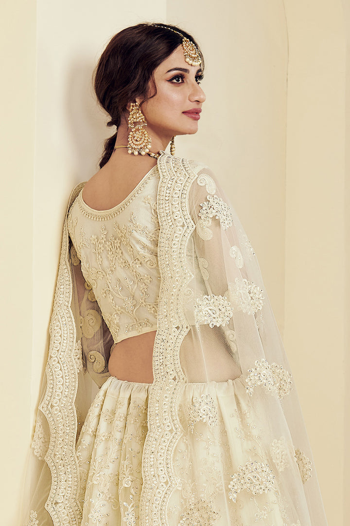 Fancy Net Fabric Sangeet Wear Off White Color Embroidered Lehenga Choli