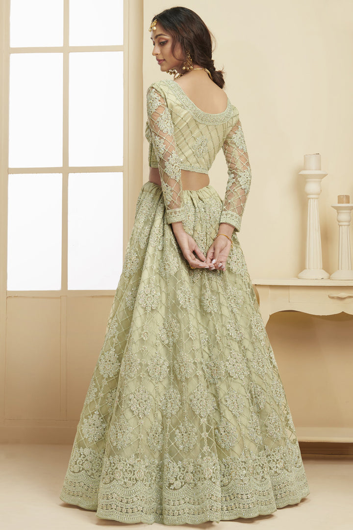Fancy Net Fabric Sangeet Wear Embroidered Sea Green Color Lehenga